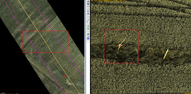 Gas pipeline corridor crossing an open field with a leaning marker post