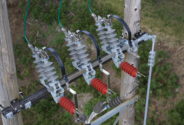 Close-up of insulator fittings on a transmission line pole